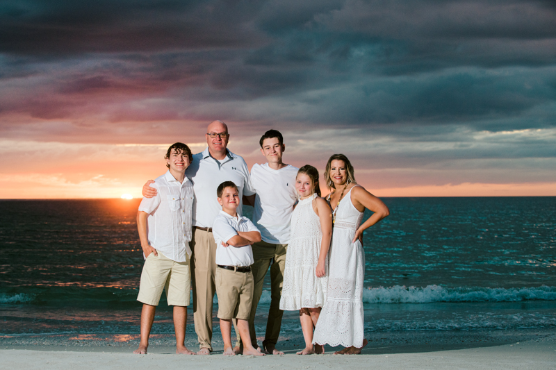 Family dressed in white at Clearwater Beach smiling