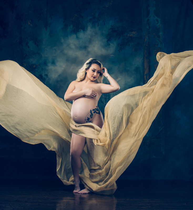 Pregnant woman poses with yellow cloth for boudoir photography